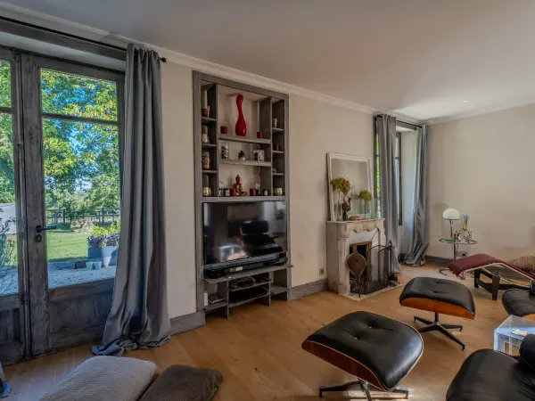 Salon avec bibliothèque et accès direct au jardin.